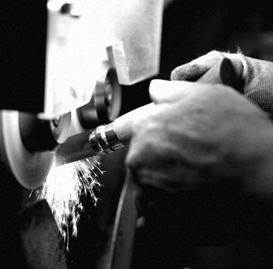 Image in black and white of the manufacturing process of sharpening knife 