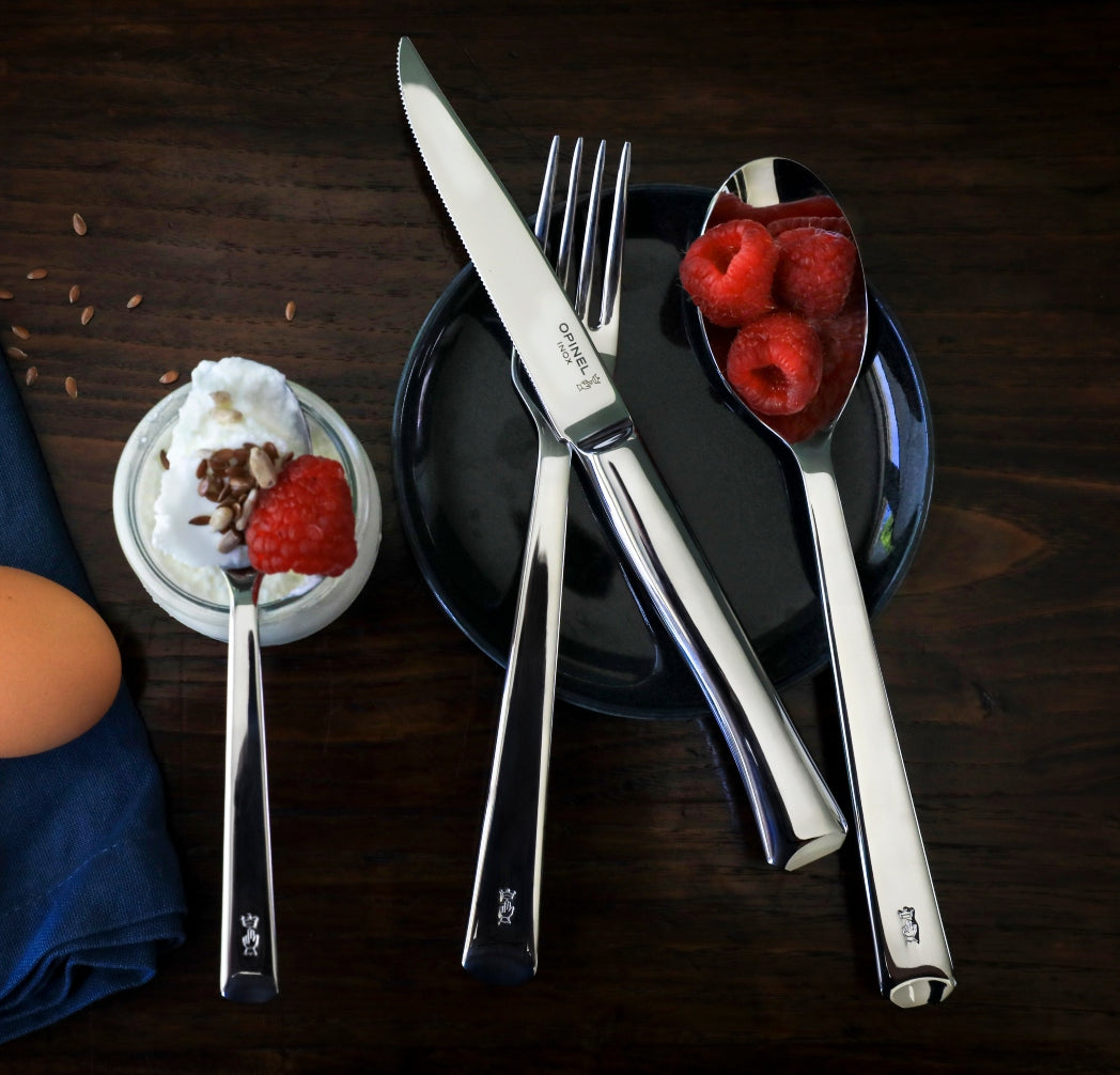 Perpetue cutlery set luxury table setting. Image with light tea foods such as egg, yogurt and raspberries 